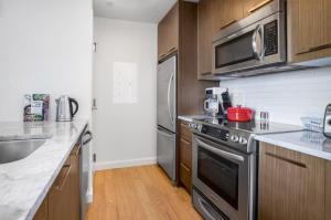a kitchen with a stainless steel stove and microwave at Open Back Bay 1BR w Gym nr the Common BOS-2 in Boston