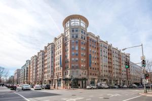 a large building on a city street with a traffic light at Foggy Bottom 1BR w Gym Pool DM nr World Bank WDC-163 in Washington, D.C.