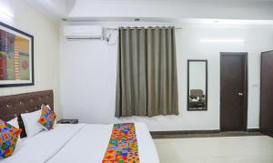 a hotel room with a bed and a window at FabHotel F9 H Block Sector 51 in Noida