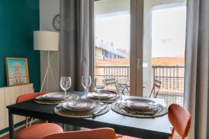 una mesa de comedor con platos y copas de vino en Cocon Urbain à 2 pas de la Gare, en Nantes 6 fotos más