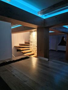 a room with a table and stairs with blue lights at Walthouse in Vulcan