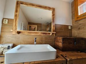 a bathroom with a white sink and a mirror at Chalupa Na Seníku - Beskydy, Valašsko - roubenka na samotě s výhledem in Vsetín