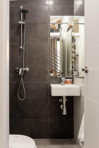 a bathroom with a sink and a shower at Acanthus in Seville