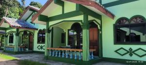 a house painted in green and white at Kata Vl2_Superior in Ban Karon