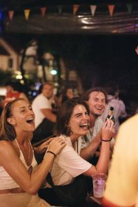a group of people sitting in a crowd at a party at Blanco Hostel Lanta 18 to 35 in Ko Lanta