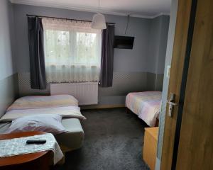 Habitación con 2 camas individuales y ventana. en Gościniec Złoty Krąg en Kobylnica