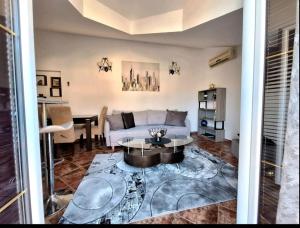 a living room with a couch and a table at Rose Apartment in Kotor
