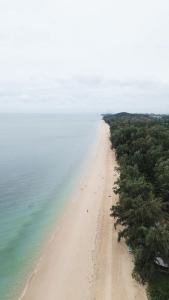 an aerial view of a sandy beach next to the ocean at Blanco Hostel Lanta 18 to 35 in Ko Lanta