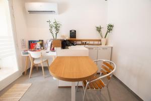 a small kitchen with a wooden table and chairs at Gest in Mellieħa