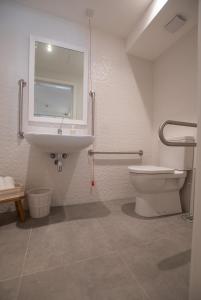 a bathroom with a toilet and a sink and a mirror at Gest in Mellieħa