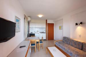 a living room with a couch and a table at Apartamentos La Caseta - SABESA in Benidorm