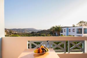 a bowl of fruit on a table on a balcony at Hotel Marilen in Alinda