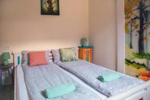 a large bed with pillows on it in a room at Seek and Hide - Little Emma's Hideaway in Braşov +13 photos