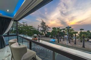 a balcony with chairs and a view of the beach at Karon Sea Sands Resort-SHA PLUS in Karon Beach