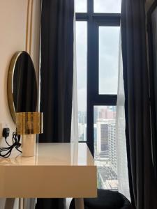 a desk in front of a window with a view at AXON APARTMENT RESIDENTIAL SUITE in Kuala Lumpur