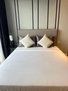 a large white bed with two pillows on it at AXON APARTMENT RESIDENTIAL SUITE in Kuala Lumpur