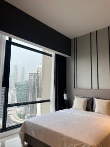 a bedroom with a bed and a large window at AXON APARTMENT RESIDENTIAL SUITE in Kuala Lumpur