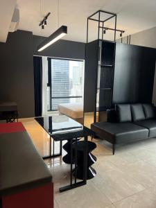 a living room with a black table and a couch at AXON APARTMENT RESIDENTIAL SUITE in Kuala Lumpur