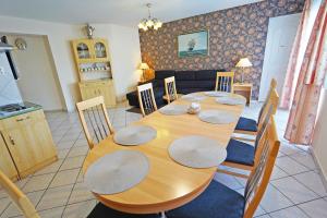 a dining room with a wooden table and chairs at Apartman Brigitte Bükfürdő in Bük