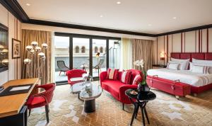 a hotel room with a bed and red furniture at Dinamo Hotel Baku in Baku