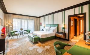 a hotel room with a bed and a table and chairs at Dinamo Hotel Baku in Baku