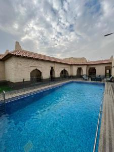 une grande piscine en face d'un bâtiment dans l'établissement شاليهات أندلوسيا, à Riyad
