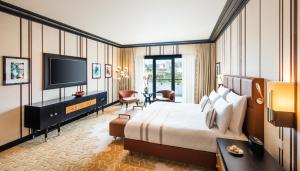 a hotel room with a bed and a flat screen tv at Dinamo Hotel Baku in Baku