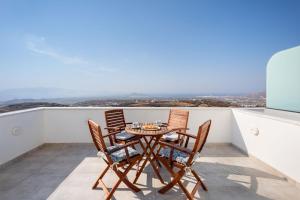 a table and chairs on a balcony with a view at Mandilaras Village in Vívlos