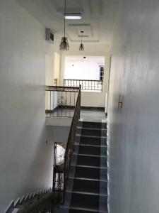 a stairway in a building with a stair case at Brandison Apartments in Rumodome