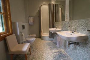 a bathroom with two sinks and a toilet and a shower at Haus Tanegg in Innsbruck