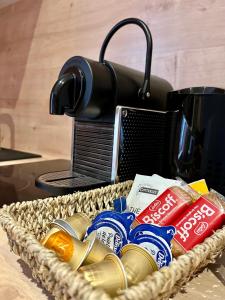 a basket of food sitting on a table with a coffee maker at LesCinqSuites/ Le Marrakech - DABNB in Limoges