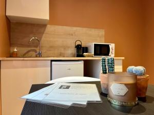 a table with a cup of coffee on a counter at LesCinqSuites/ Le Marrakech - DABNB in Limoges