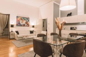 - une salle à manger et un salon avec une table et des chaises en verre dans l'établissement Tergesteo Adriatic Suite, à Trieste