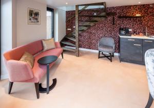 a living room with a couch and a table and chairs at Bed & Breakfast Ons Plekje in Zwolle