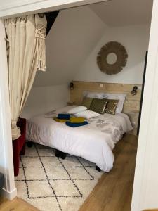 a bedroom with two beds and a mirror on the wall at Cosy & Tendance Spa in Poitiers