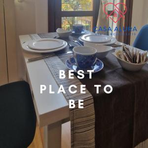 a table with plates and bowls on top of it at Casa Alura in Bergamo