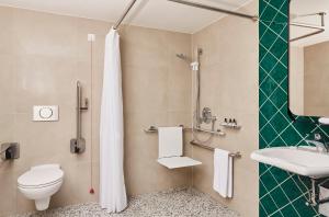 a bathroom with a toilet and a sink at Hotel Indigo Berlin - East Side Gallery in Berlin