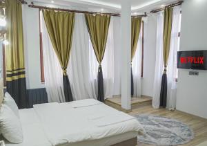 a bedroom with two beds and some windows at Mar Suite in Istanbul