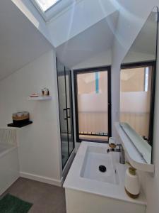 a bathroom with a sink and two windows at Le Saphir - Centre - Confort - 6p - Rêve au Mans in Le Mans