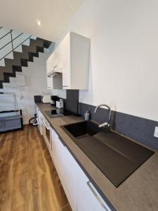 a kitchen with a sink and a staircase at Le Saphir - Centre - Confort - 6p - Rêve au Mans in Le Mans