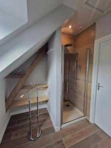 a bathroom with a shower under the stairs at La Grange - Campagne - Piscine 15p - Rêve au Mans in Thorée-les-Pins