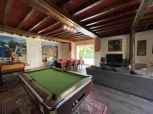 a living room with a pool table in it at La Grange - Campagne - Piscine 15p - Rêve au Mans in Thorée-les-Pins