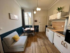 a kitchen with a couch and a table in a room at Le Nomade - Gare - 3 pers - Rêve au Mans in Le Mans