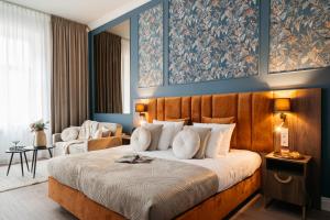 a bedroom with a large bed with blue walls at White Lotus - LoftAffair Collection in Kraków