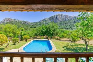 a view from a balcony of a swimming pool and mountains at Can Pep, chalet con piscina en Pollensa in Pollença