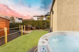 a hot tub in the backyard of a house at Ellerthwaite Place X3 Bed House with Hot Tub in Central Windermere in Windermere