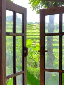 an open door looking out at a green field at Lua Pu Luong in Pu Luong