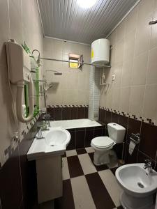 a bathroom with two sinks and a toilet at Hello Dushanbe Guest House in Dushanbe