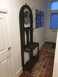 a black shelf with a mirror next to a door at Stylish ground floor 2 bedroomed apartment. in Barrow in Furness