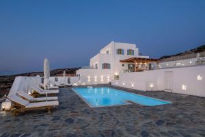 a swimming pool with lounge chairs and a house at Mandilaras Village - The Panorama of Naxos in Vívlos +42 photos